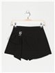 Short falda lazo pedrería negro